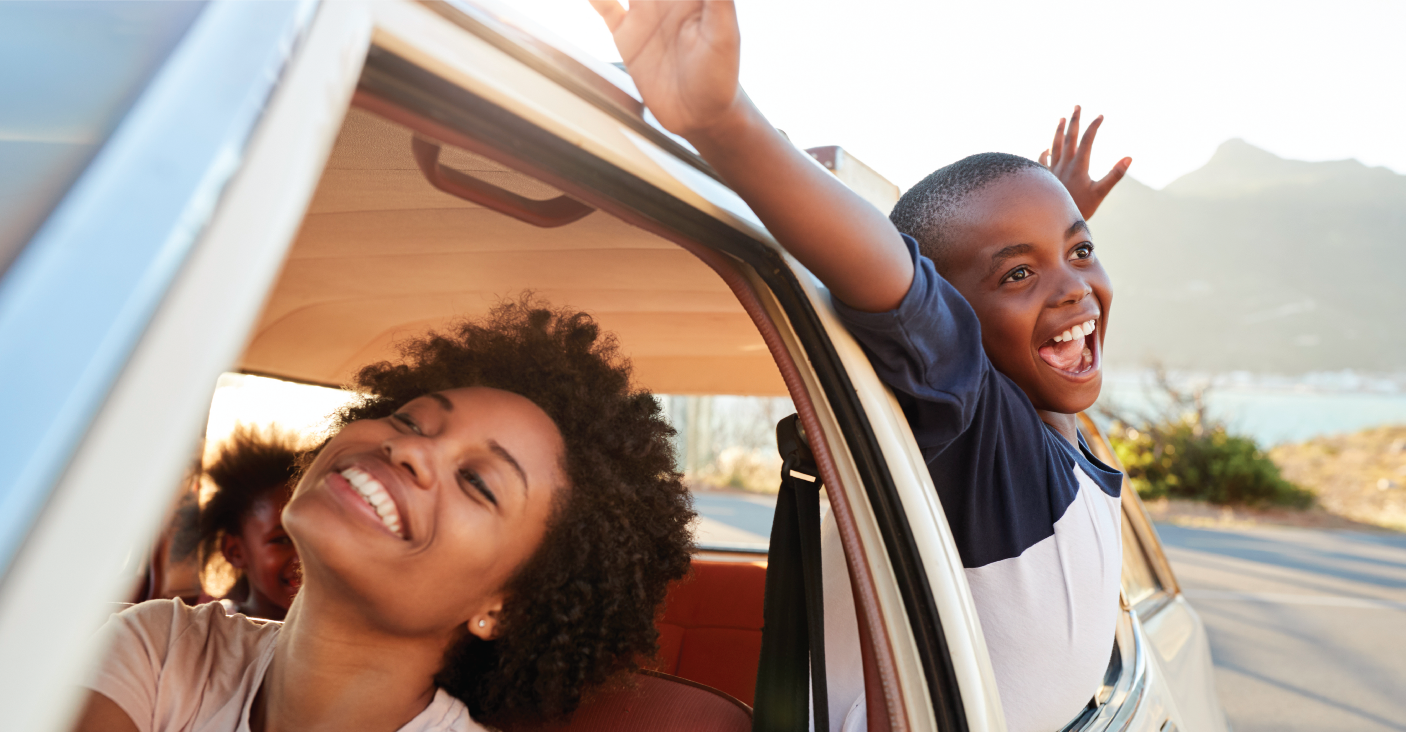 Happy Family Driving In Car