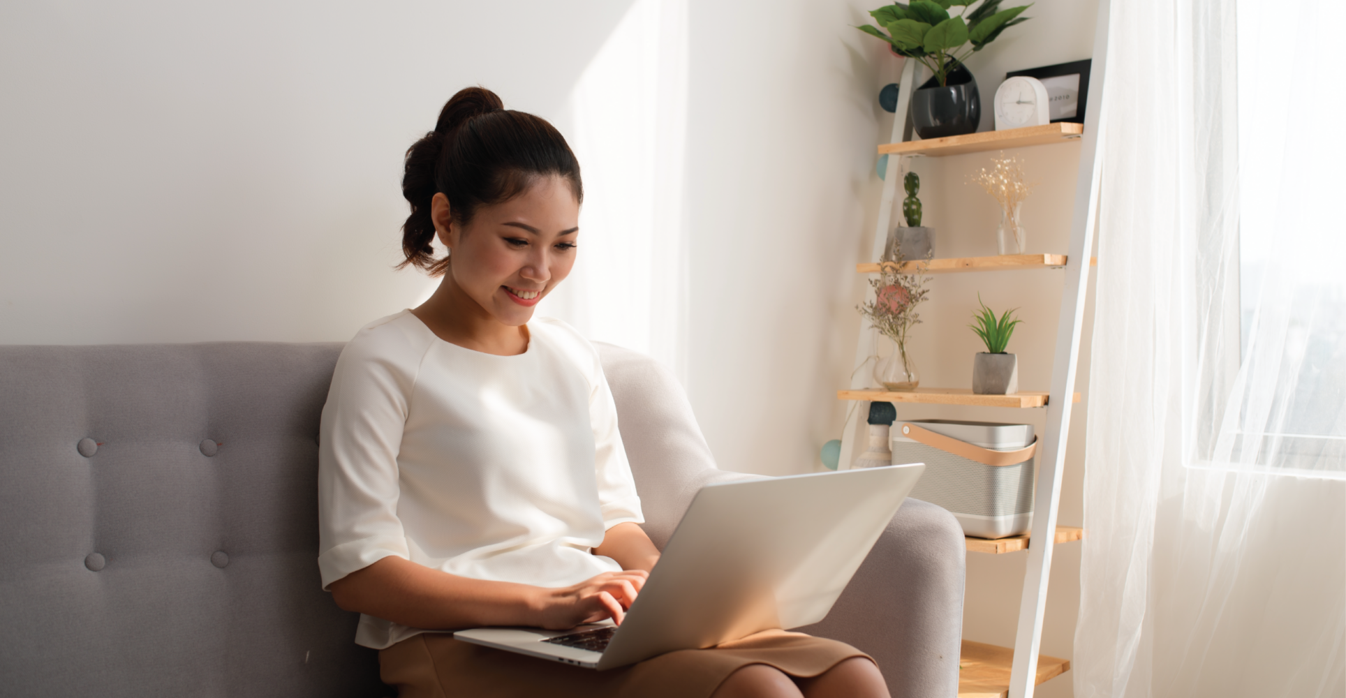 Woman Using Computer On Couch